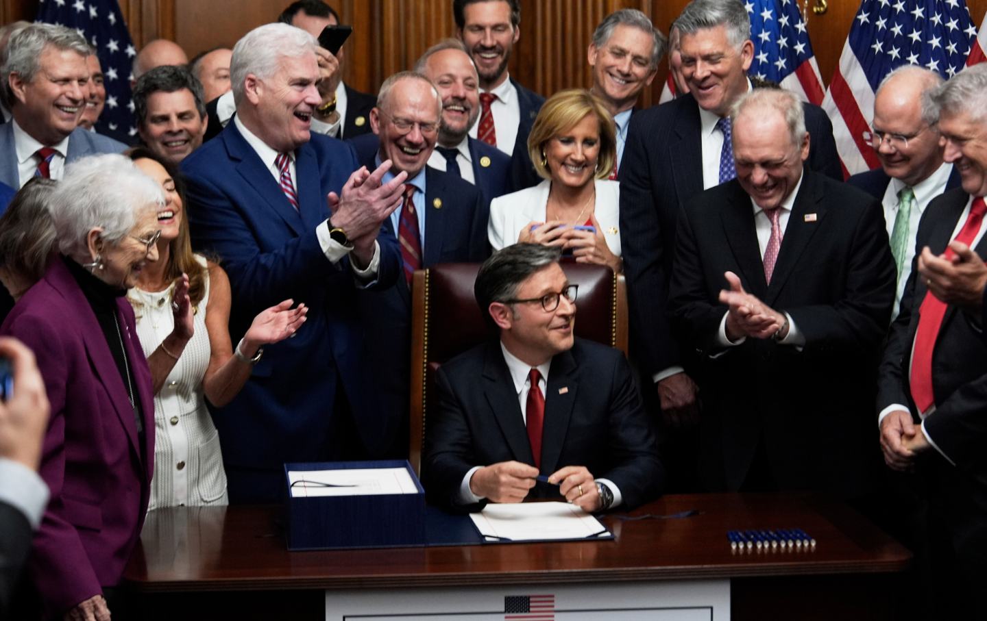 Speaker of the House Mike Johnson (R-LA), surrounded by Republican members of Congress, signs President Donald Trump's signature bill of tax breaks and spending cuts, July 3, 2025, at the Capitol, Washington, DC.