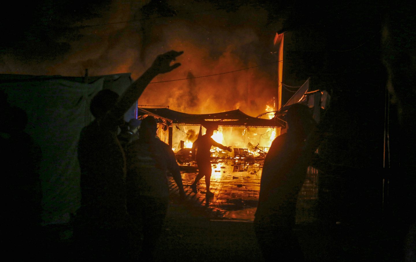 Fire breaks out on the tents of displaced Palestinians after Israeli attacks in the garden of Al-Aqsa Martyrs Hospital in Gaza City, Gaza, on October 14, 2024.