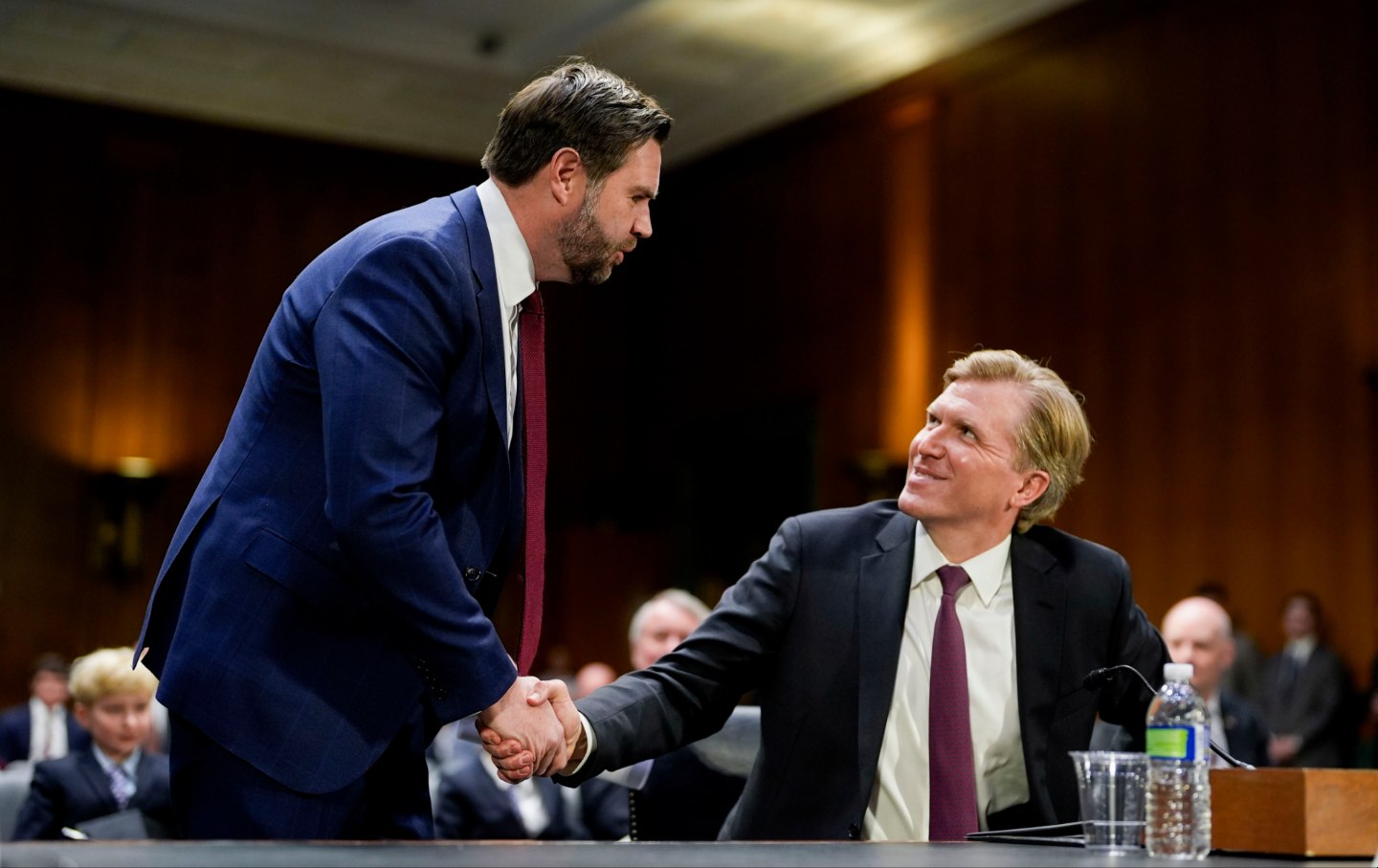 US Vice President JD Vance, left, and Elbridge Colby, under secretary of defense for policy nominee for US President Donald Trump, shake hands during a Senate Armed Services Committee confirmation hearing in Washington, DC, US, on Tuesday, March 4, 2025.