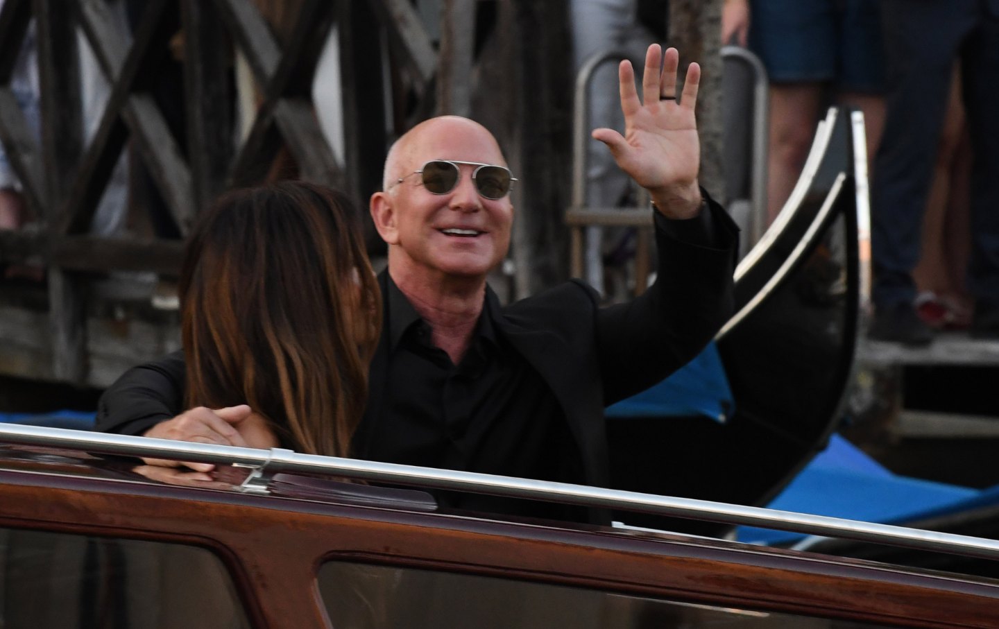 Jeff Bezos and Lauren Sanchez wave as they exit the Hotel Aman Wedding on June 28, 2025 in Venice, Italy.