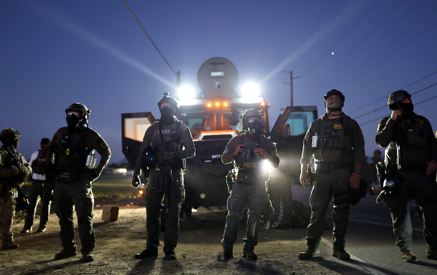 Federal agents block people protesting an ICE immigration raid at a nearby licensed cannabis farm on July 10, 2025, near Camarillo, California.
