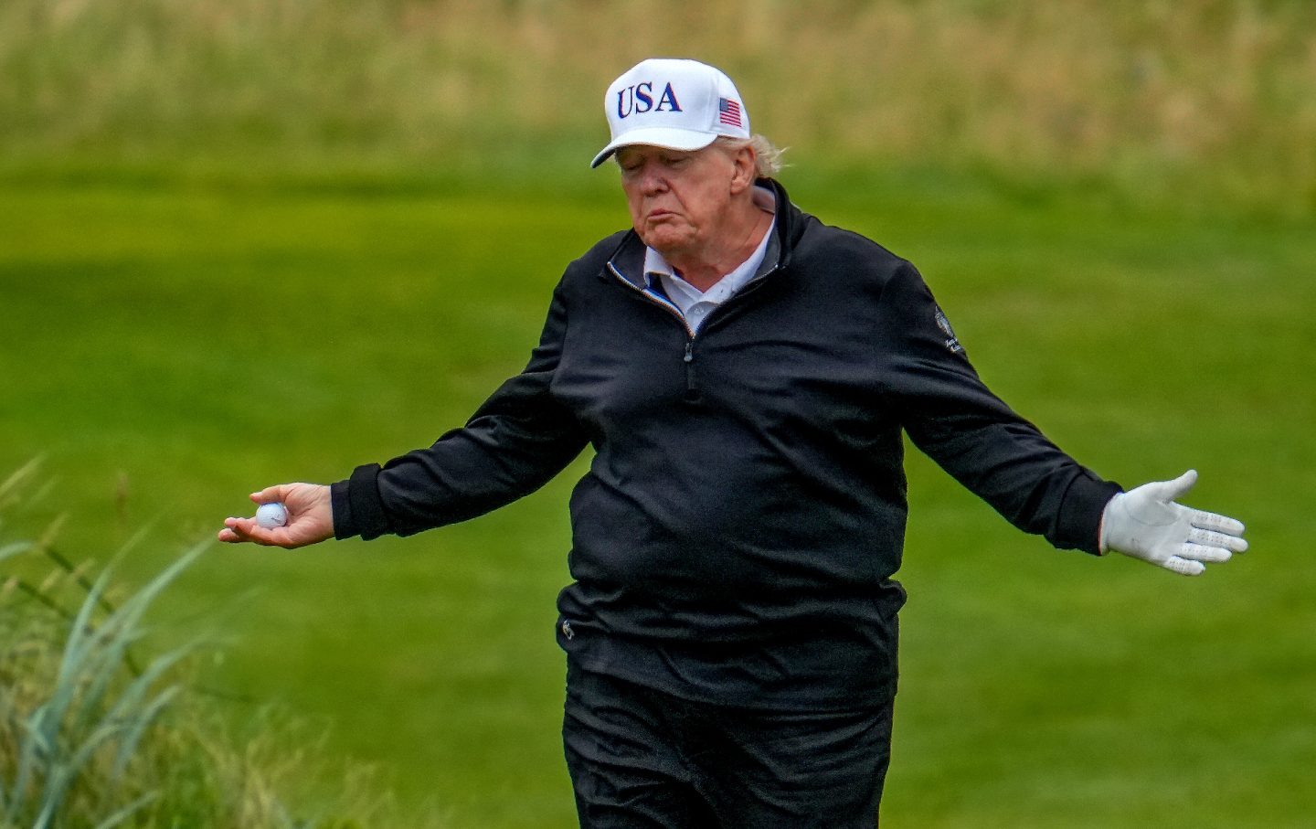 Donald Trump reacts as he plays a round of golf at Trump Turnberry golf course during his visit to the UK on July 27, 2025.