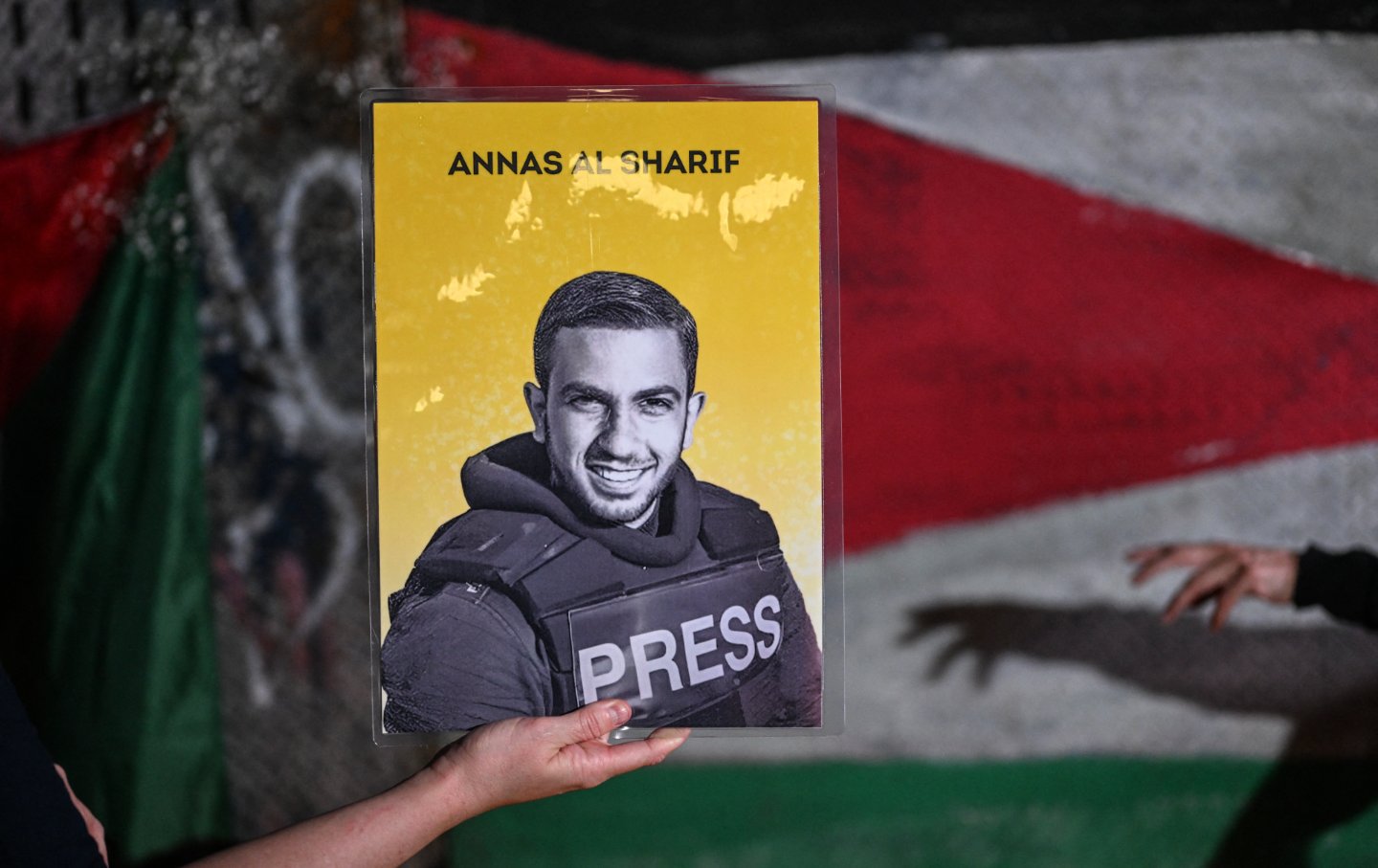A woman holds a picture of Anas al-Sharif, one of journalists killed by an Israeli strike in the Gaza Strip, while attending a vigil in Mexico City on August 12, 2025.