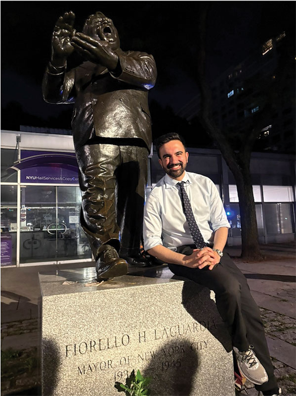 Mamdani poses alongside a statue of Fiorello LaGuardia.