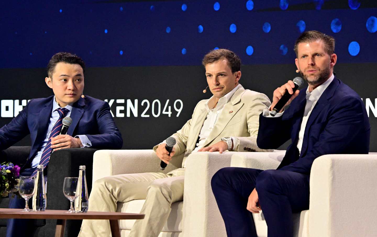 Justin Sun, head of the Tron crypto exchange (L) talks with World Liberty Financial cofounder Zach Witkoff (C) and Eric Trump of the Trump Organization at a May crypto conference in Dubai